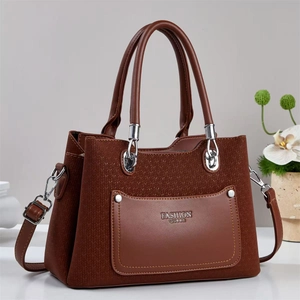 Detail of brown woven texture PU leather tote bag with silver rivets and metal hardware