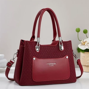 Close-up of wine red tote bag featuring quilted texture and Fashion Queen silver logo