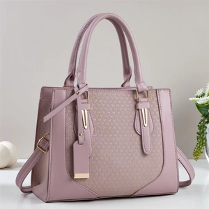 Elegant mauve leather handbag with woven texture detail and gold metal hardware