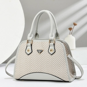 Elegant shell-shaped grey and beige patchwork handbag with gold metal logo and top handles