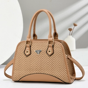 Elegant herringbone shell handbag in beige and brown with classic top handles and metal logo