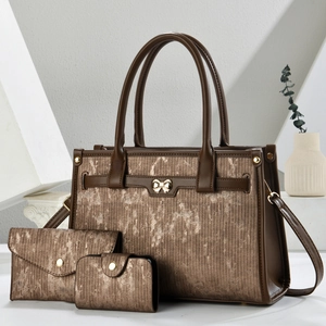 Three-piece women's bronze tote bag set with matching wallet and textured finish