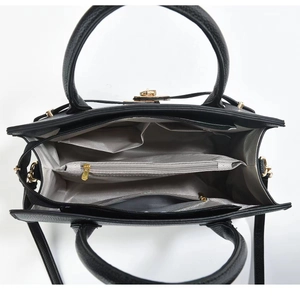 Overhead view of black tote bag interior with multiple compartments and chevron lining