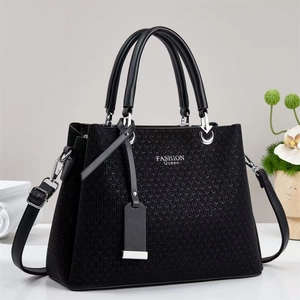 Close-up of woven texture and silver hardware on black large capacity handbag