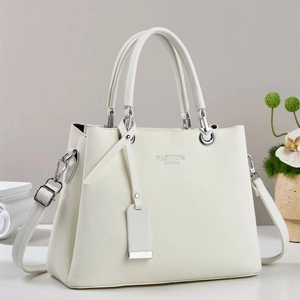 Close-up of white lychee pattern leather tote with silver hardware and fashion text
