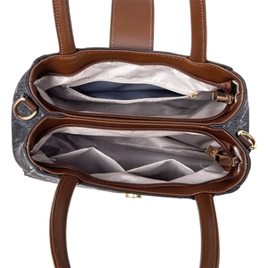 Detail view of large capacity interior with multiple compartments and gold zipper on handbag