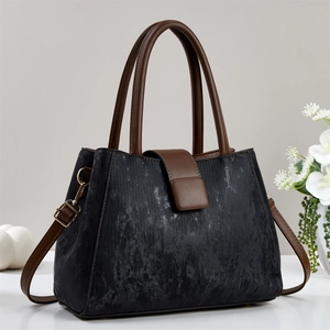 Classic black and brown tote bag with vintage texture and golden metal hardware