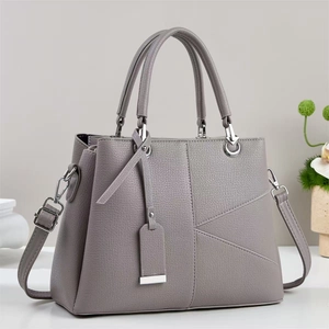 Grey textured leather handbag with geometric stitching and silver metal hardware