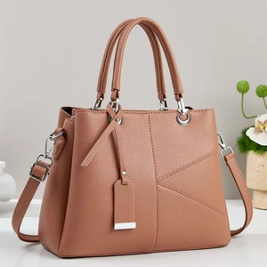 Classic caramel brown pebbled PU leather handbag with crossbody strap and geometric stitching