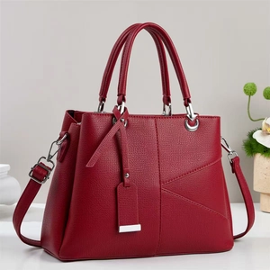 Detailed view of a dark red litchi grain tote bag with silver hardware and shoulder strap