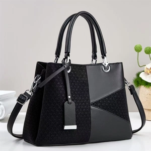 Elegante borsa a mano in pelle nera e tessuto a spina di pesce con finiture argentate