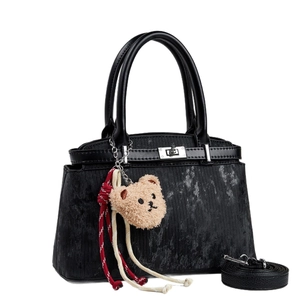Black corduroy handbag with vintage print, teddy charm, and detachable shoulder strap