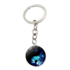 Detailed close-up of Yin Yang Tai Chi fish keychain with a cosmic star galaxy pattern
