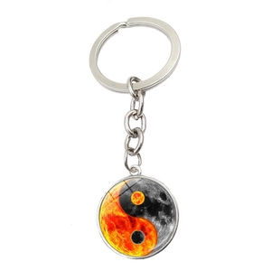 Detailed view of Yin Yang keychain featuring sun and moon graphics with crystal glass inlay