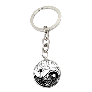 Silver dragon and tiger yin yang pendant keychain with polished metal finish on white background