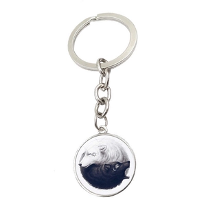 Detailed view of Yin Yang wolf glass cabochon pendant on a silver metal keychain