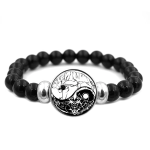 Macro view of Yin Yang dragon bead bracelet with black polished stones and silver spacer beads