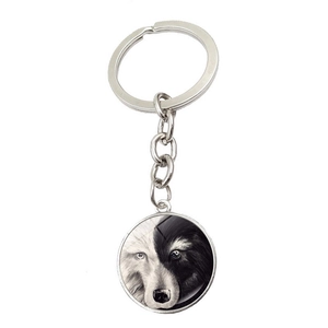 Detail of artistic black and white wolf head pendant with metal keychain chain
