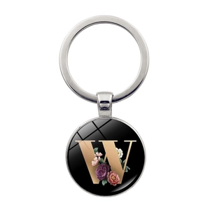 Detailed view of silver keychain with a glass floral pendant featuring golden letter W