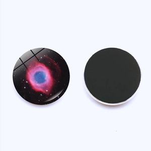 Detailed macro view of God's Eye Galaxy fridge magnet with glass dome and magnetic back