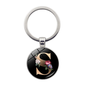 Detailed view of the letter S keychain pendant with white roses and purple floral art
