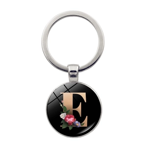 Silver alphabet keychain with letter E and floral accents on a glass pendant