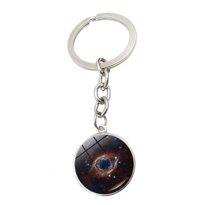 Macro detail of silver metal keychain with vibrant galaxy nebula glass pendant inlay