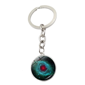 Macro shot of silver keychain featuring a circular galaxy nebula glass crystal pendant