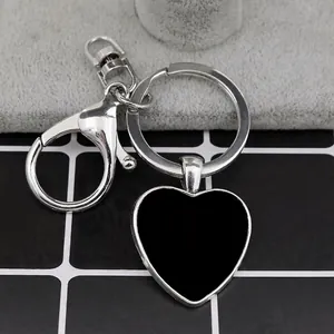 Custom heart-shaped metal keychain with silver finish and lobster clasp for engraving