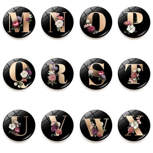 Floral alphabet magnets set with rose gold letters M-X on glossy black background