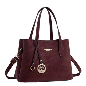 Vintage burgundy suede-like handbag with top handles and adjustable shoulder strap
