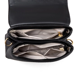 Interior view of black crossbody bag showing double zipper compartments and fabric lining