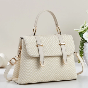 Elegant beige herringbone woven handbag with cream leather trim and gold buckle closure