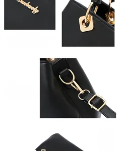 Detail of premium black textured leather handbag with polished gold hardware and logo