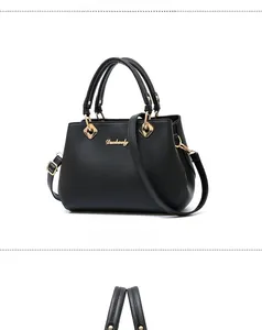 Vertical view of black lychee-grain faux leather tote bag with golden brand logo detail