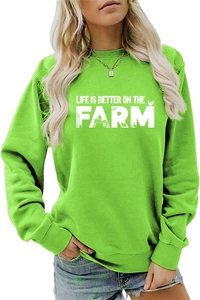 Detail of bright green crewneck sweatshirt featuring white Life Is Better On The Farm print