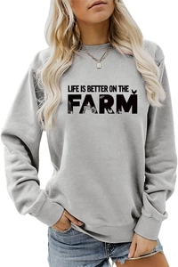 Close-up of Life Is Better On The Farm text print on grey crewneck sweatshirt