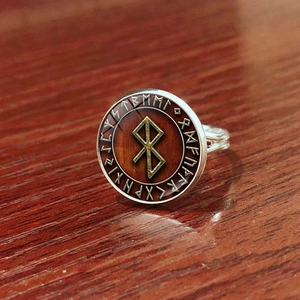 Detailaufnahme eines nordischen Wikingerrings mit Odin-Symbolen und Runengravur