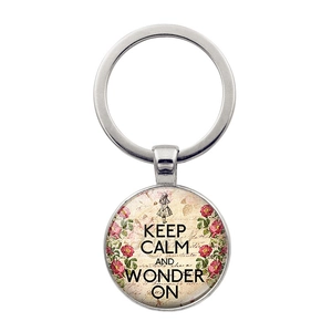 Detailed macro view of vintage Keep Calm and Wonder On round glass keychain pendant