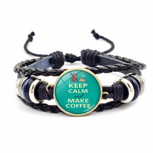 Detail of multi-layer braided leather bracelet with Keep Calm and Make Coffee glass gem