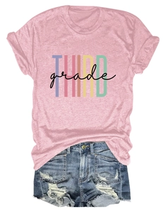 Detailed close-up of colorful THIRD GRADE letter print on a pink cotton short sleeve t-shirt