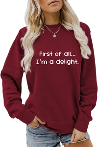 Detail of maroon sweatshirt with 'First of all' white typography and crew neck design