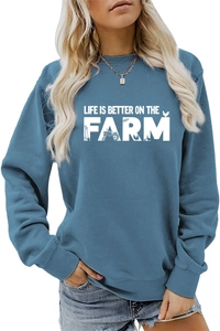 Detail of teal crewneck sweatshirt with white Life Is Better On The Farm graphic print