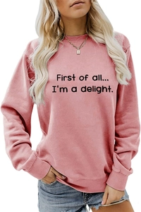 Detail of pink crewneck sweatshirt featuring First of all text print and ribbed cuffs