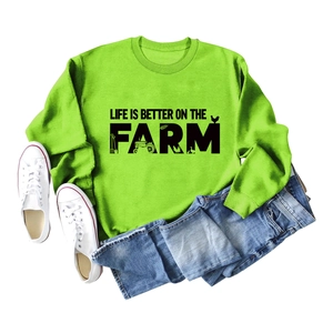 Detail of neon green crewneck sweatshirt with Life Is Better On The Farm graphic print