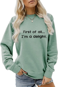 Detail of sage green sweatshirt featuring ribbed cuffs and First of all letter print