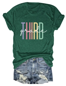 Close-up of forest green t-shirt with THIRD grade print and distressed denim shorts