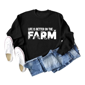 Flat lay of black crewneck sweatshirt with Life Is Better On The Farm white graphic print