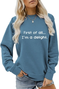 Detail of blue crewneck sweatshirt featuring white First of all I'm a delight slogan