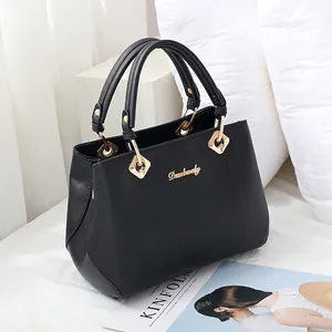 Classic black faux leather handbag for women with gold hardware and top handles